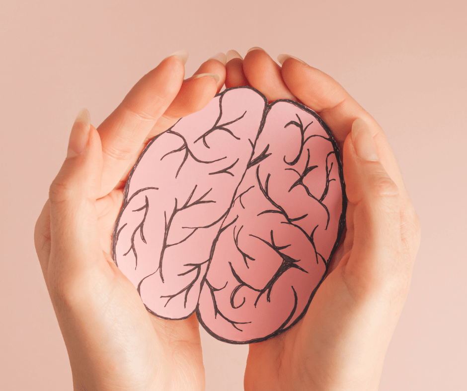 hands holding print-out of brain to symbolize mental health