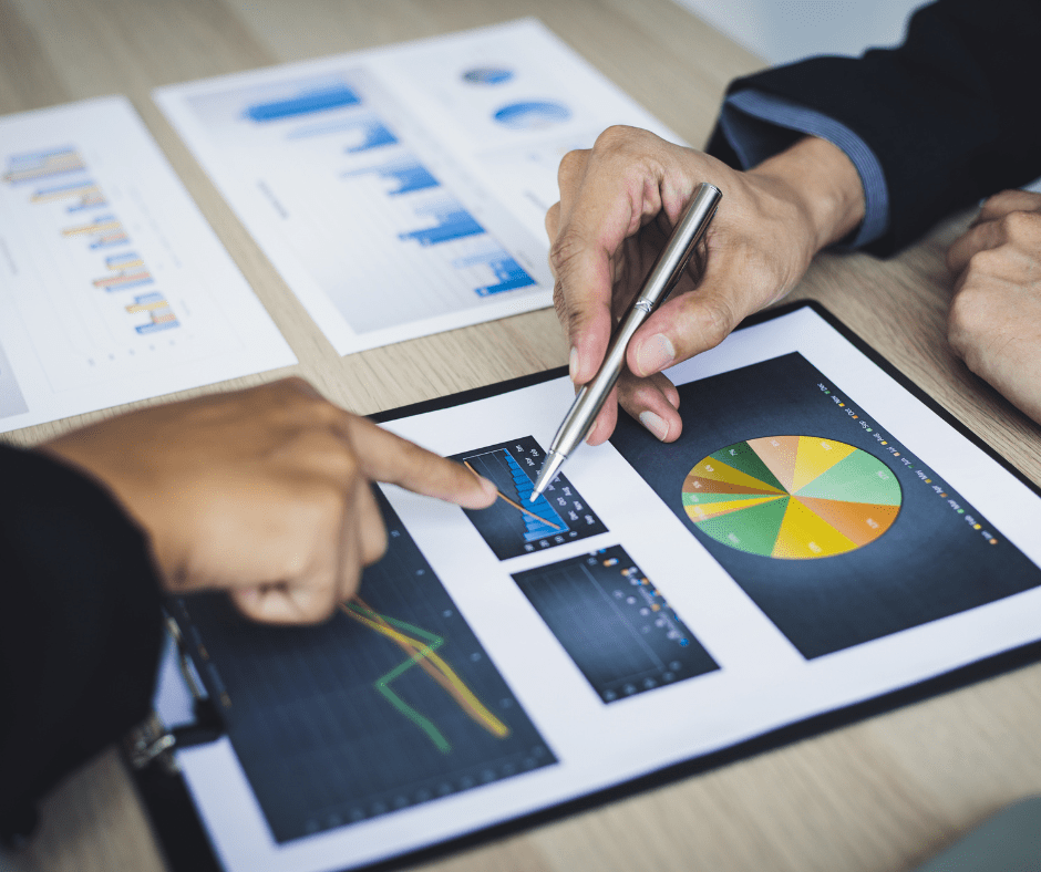 hands pointing to a data chart