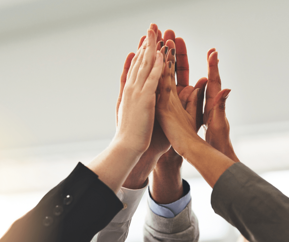 group of people's hands clapping together