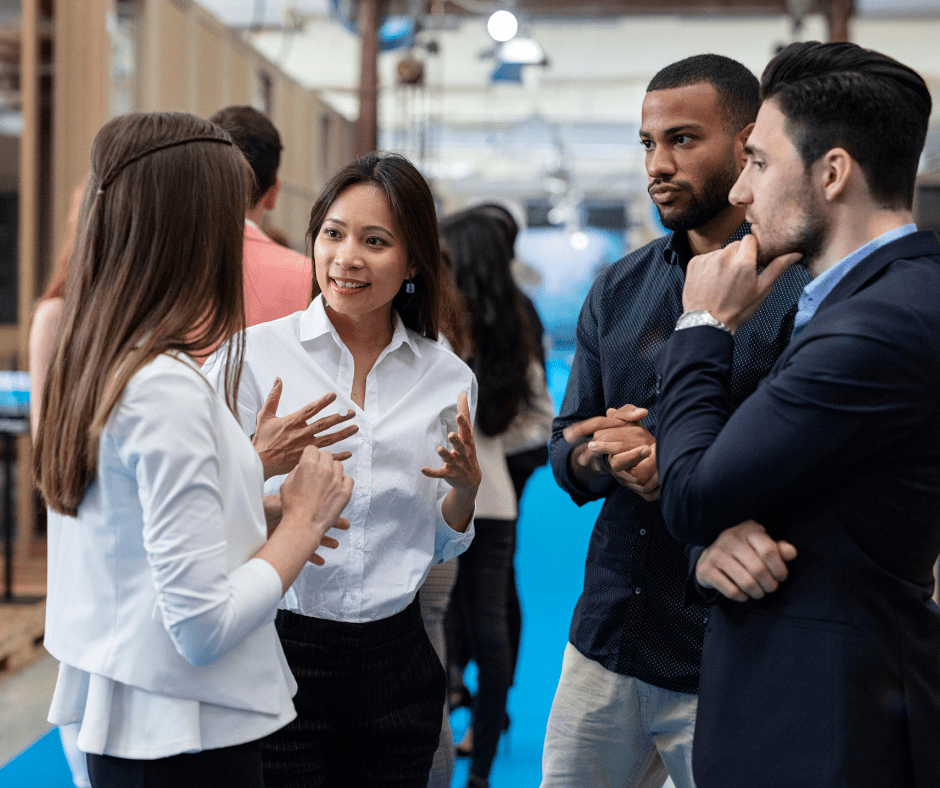 four people networking at an event