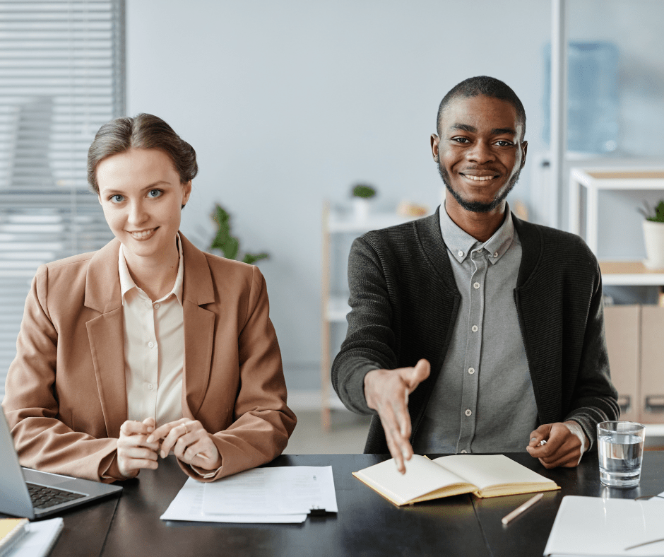 Two HR professionals one with hand out-stretched