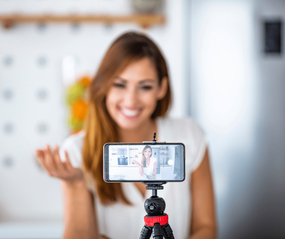 woman recording herself on a phone tripod