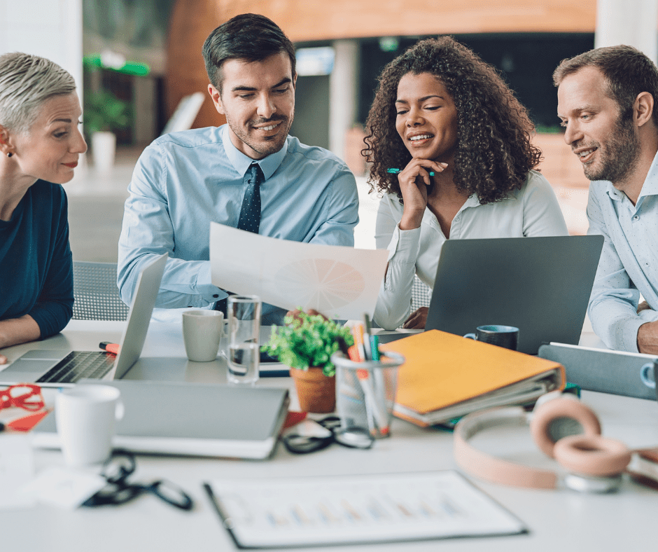 group of smiling people at a business meeting