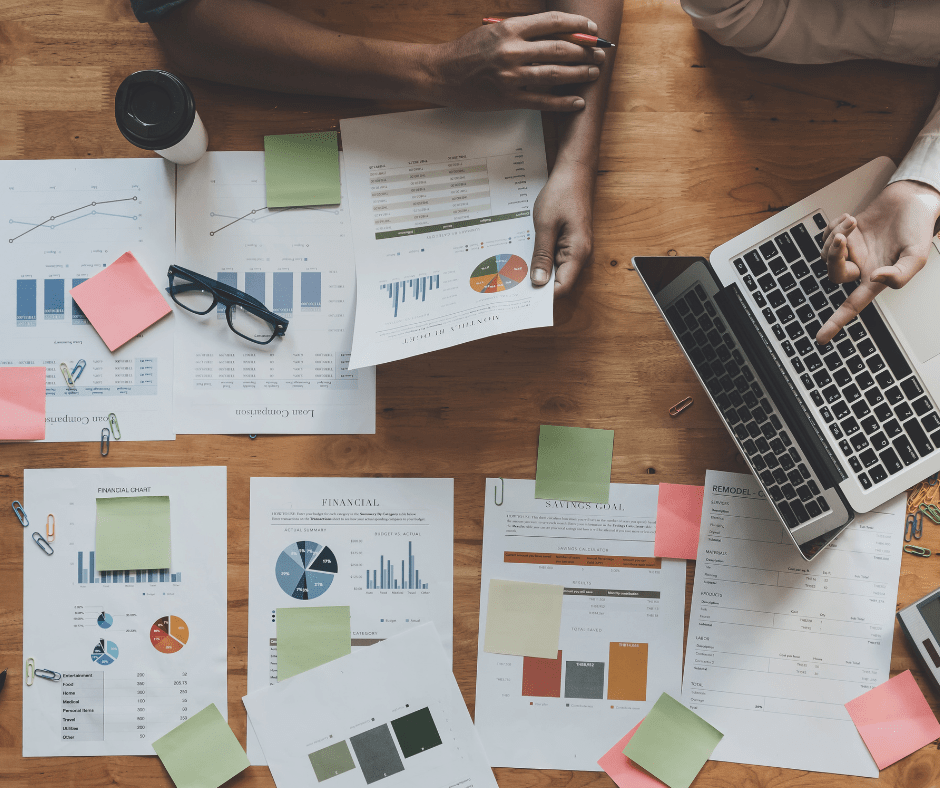 Papers on a desk with data and charts on them